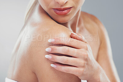 Buy stock photo Beauty, body and zoom of a woman hand for self care and skincare on a grey studio background. Cosmetic, bodycare and skin care of a female arm or shoulder for health or wellness on a backdrop