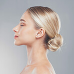 Face, beauty and skincare with the profile of a woman in studio on a gray background for wellness or treatment. Luxury, wellness and cosmetics with a model female posing to promote a natural product