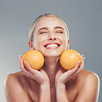 Orange, skincare and woman in studio with fruit for a natural beauty facial cosmetics product with mockup space. Smile, vitamin c and happy young girl detoxing her glowing face organically to relax