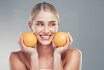 Orange, skincare and woman thinking of cosmetics, beauty and health of body against a grey mockup studio background. Happy, healthy and young model with vitamin c fruit for wellness and diet