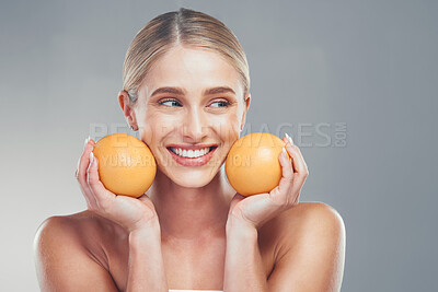 Buy stock photo Orange, skincare and woman thinking of cosmetics, beauty and health of body against a grey mockup studio background. Happy, healthy and young model with vitamin c fruit for wellness and diet