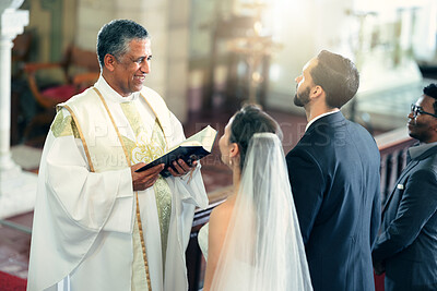 Buy stock photo Wedding, couple and priest with a bible in church praying to God with a Christian pastor reading the holy book. Love, bride and groom say an oath for a faithful and spiritual marriage commitment
