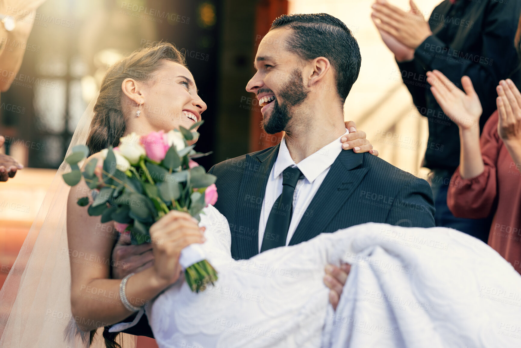 Buy stock photo Love, wedding and man carrying woman at church after marriage ceremony with applause of friends and family. Happy, smile and celebration of married bride and groom after event with audience clapping.