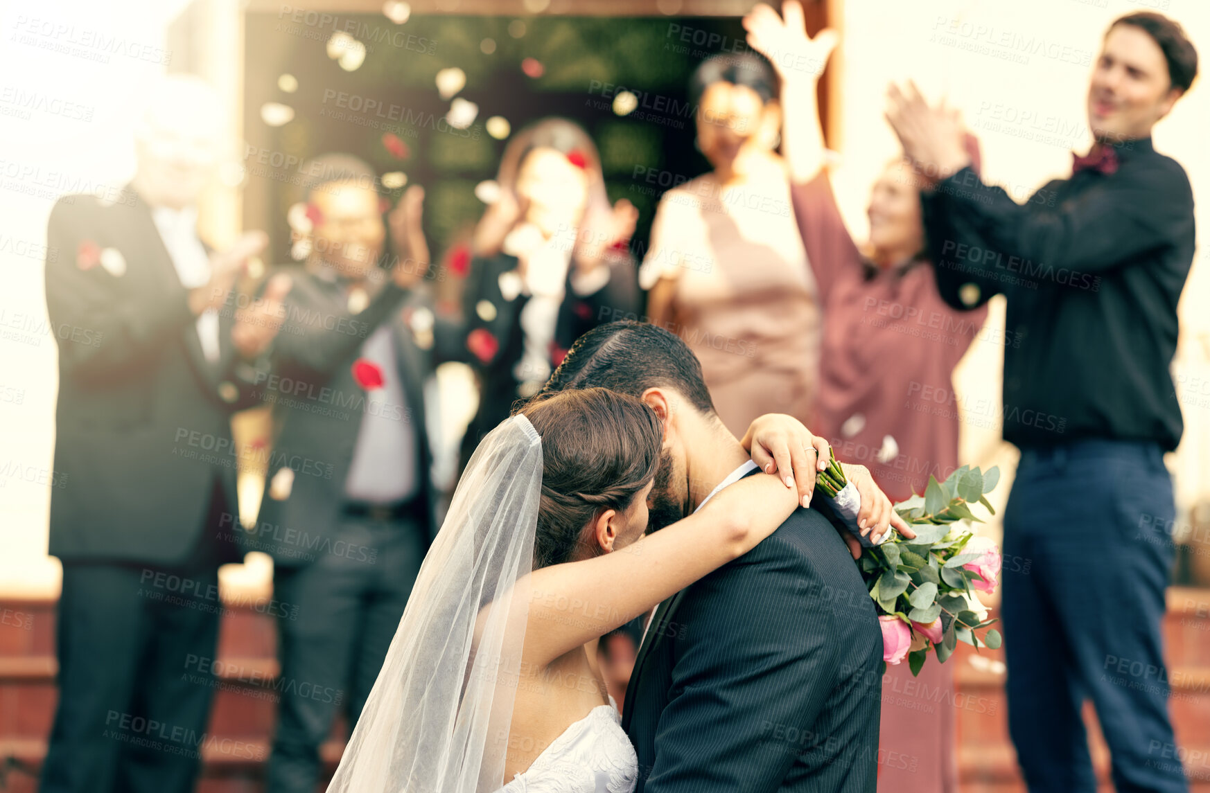 Buy stock photo Bride, groom and kiss in wedding celebration with applause from family, friends or guests at the church. Man and woman couple kissing, hugging or embracing marriage in romance for happy relationship