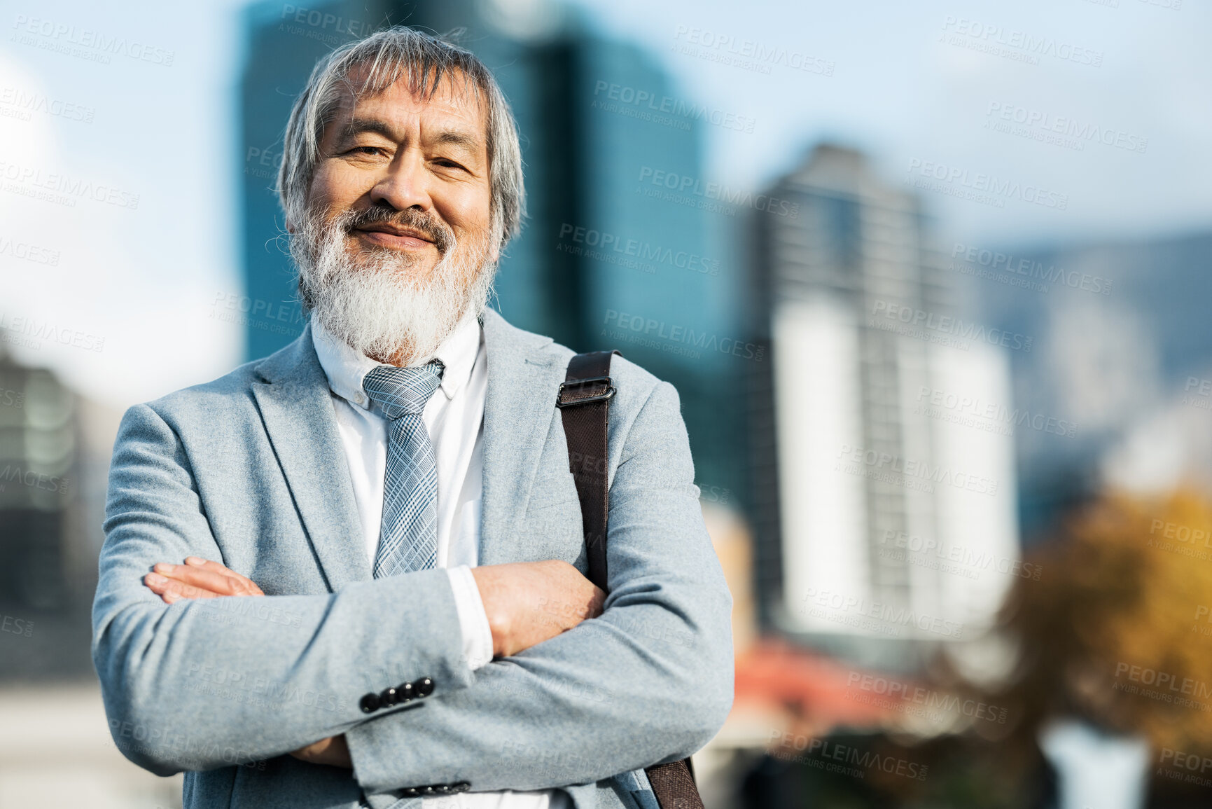 Buy stock photo Mature asian businessman, portrait and proud man in the city during a commute or journey to work. City background, executive businessperson and arms crossed while leading on an urban background