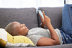 Black woman with smartphone, social media and technology with communication and relax on sofa at home. Internet, connection and young person chatting or email, streaming online or funny meme.