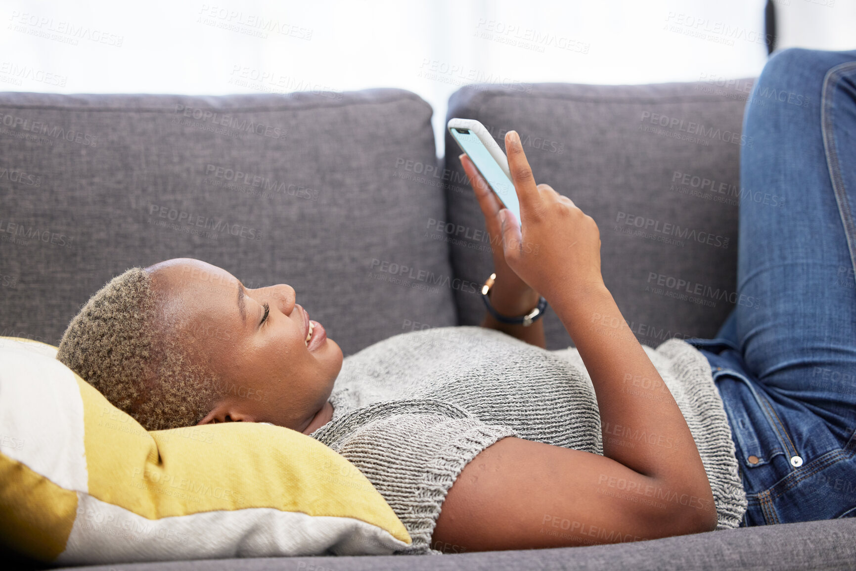 Buy stock photo Black woman with smartphone, social media and technology with communication and relax on sofa at home. Internet, connection and young person chatting or email, streaming online or funny meme.