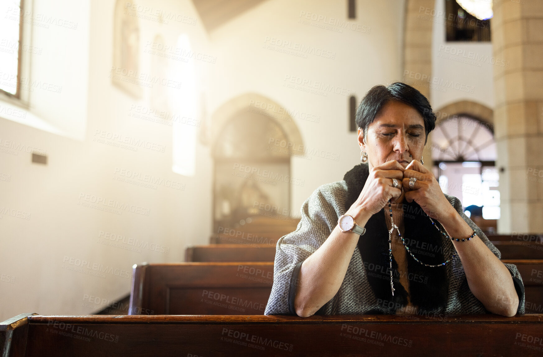 Buy stock photo Pray, church and senior woman praying with a rosary in a calm, zen chapel alone, holy and spiritual. Prayer, worship and mexican lady connect with God, Jesus and christian religion in Mexico  