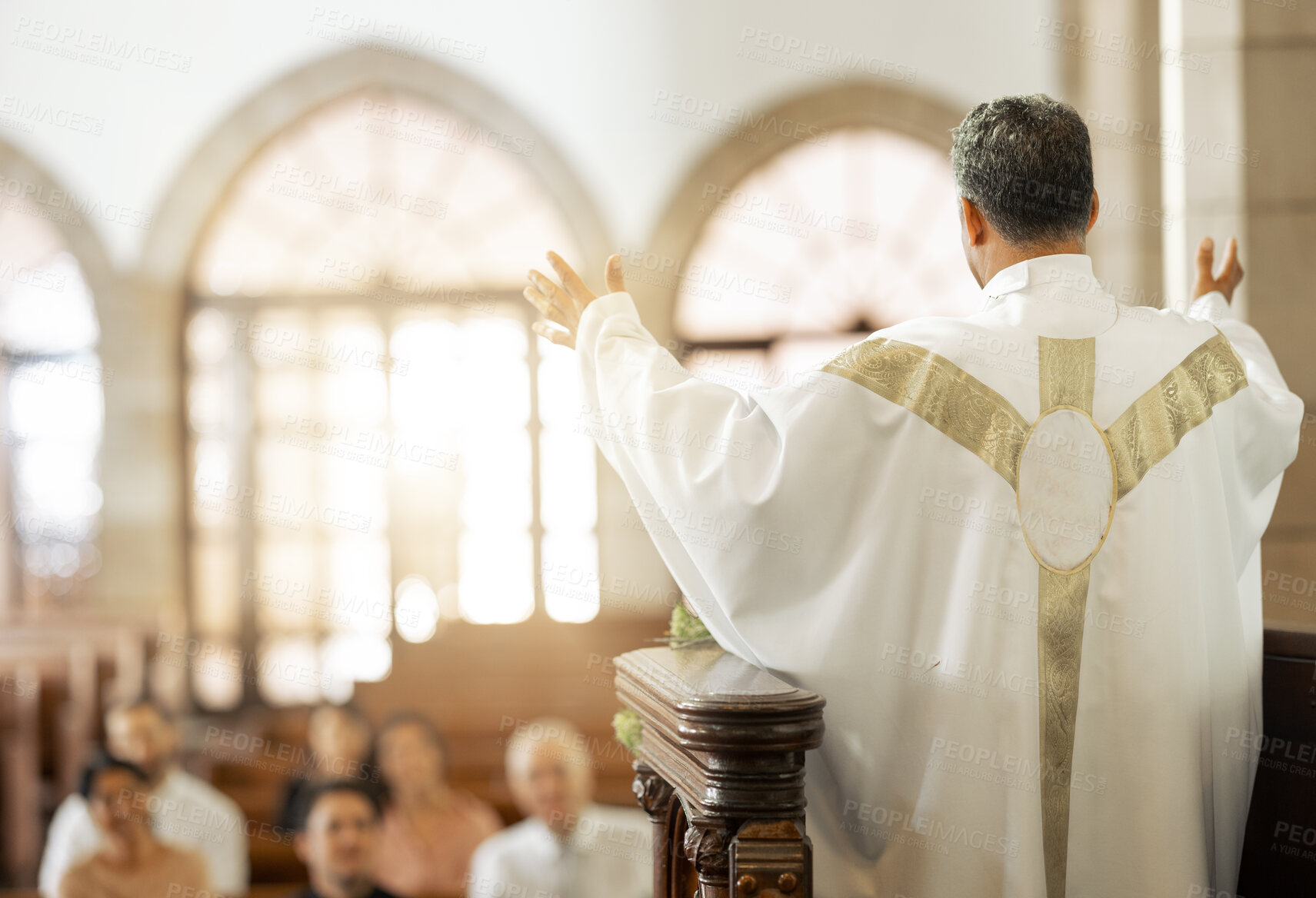 Buy stock photo Pastor, church and man praying for his congregation to god for spiritual wellness on a Sunday. Hope, religious and priest preaching to christian people standing on a podium in a cathedral building.