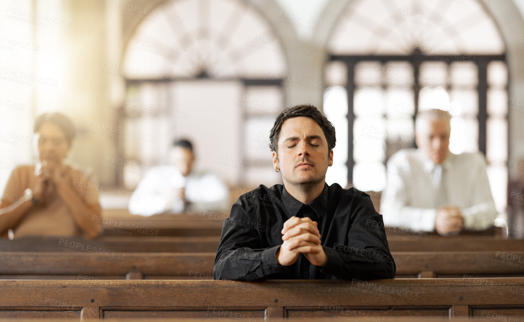 Buy stock photo Prayer, religious and young man in church with congregation, faithful and hands together. Religion, male and worship in tabernacle for guidance, spiritual and support with closed eyes and praying