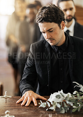 Buy stock photo Sad, funeral and coffin with man in church for death, mourning and respect at burial ceremony. Flowers, depression and grief with family goodbye at casket in chapel for loss, remember and sorrow