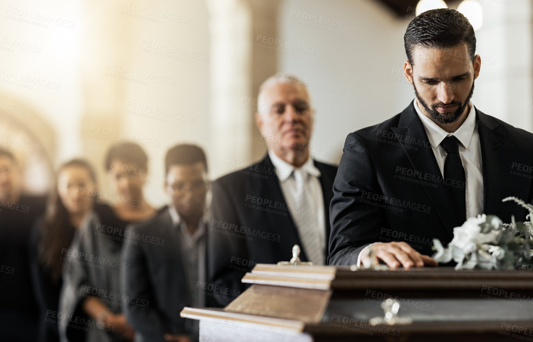 Buy stock photo People, sad and funeral coffin, death and grief in church during ceremony or service, depression or floral. Support, emotional pain and sorry with casket, mourning and man in suit at casket in chapel