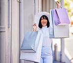 Woman, excited or fashion shopping bags on city street in Portugal for retail therapy, luxury store purchase or designer clothes sales. Portrait, smile or happy customer with gifts on road with style
