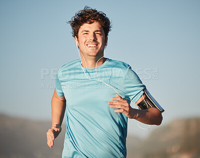 Buy stock photo Happy, running and man athlete with music steaming in nature for fitness and training in nature. Portrait of a happy, healthy and smile of a runner in the sun doing a cardio sports workout exercise