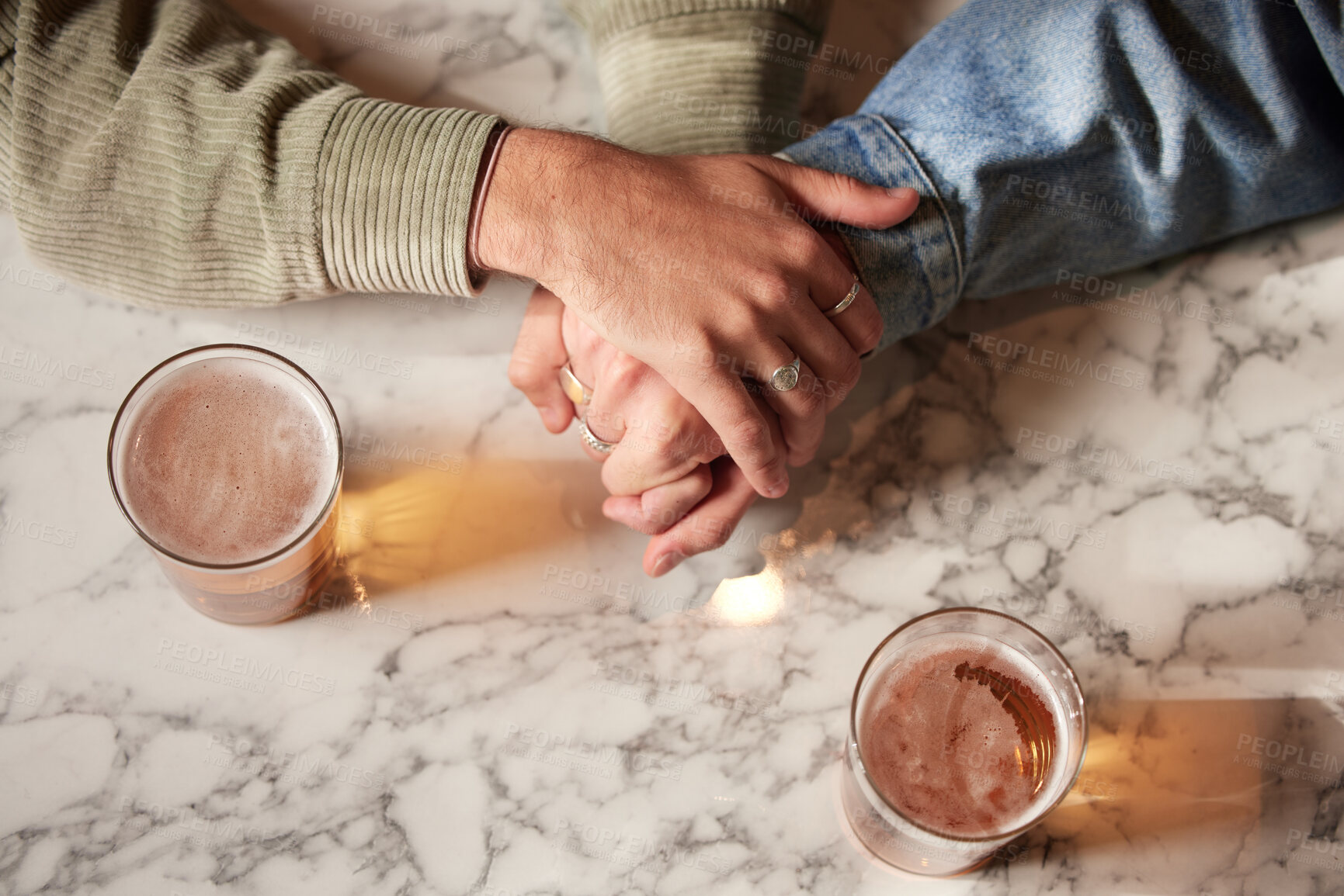 Buy stock photo Couple holding hands, above glass beer and bar with comfort, support or bonding together with drink. Helping hand, alcohol or trust with unity, love or care on countertop for empathy communication