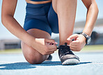 Fitness, tie and shoes of woman in stadium and training for running track, workout and sports. Exercise, health and cardio with feet of girl runner on ground for performance, endurance and athlete