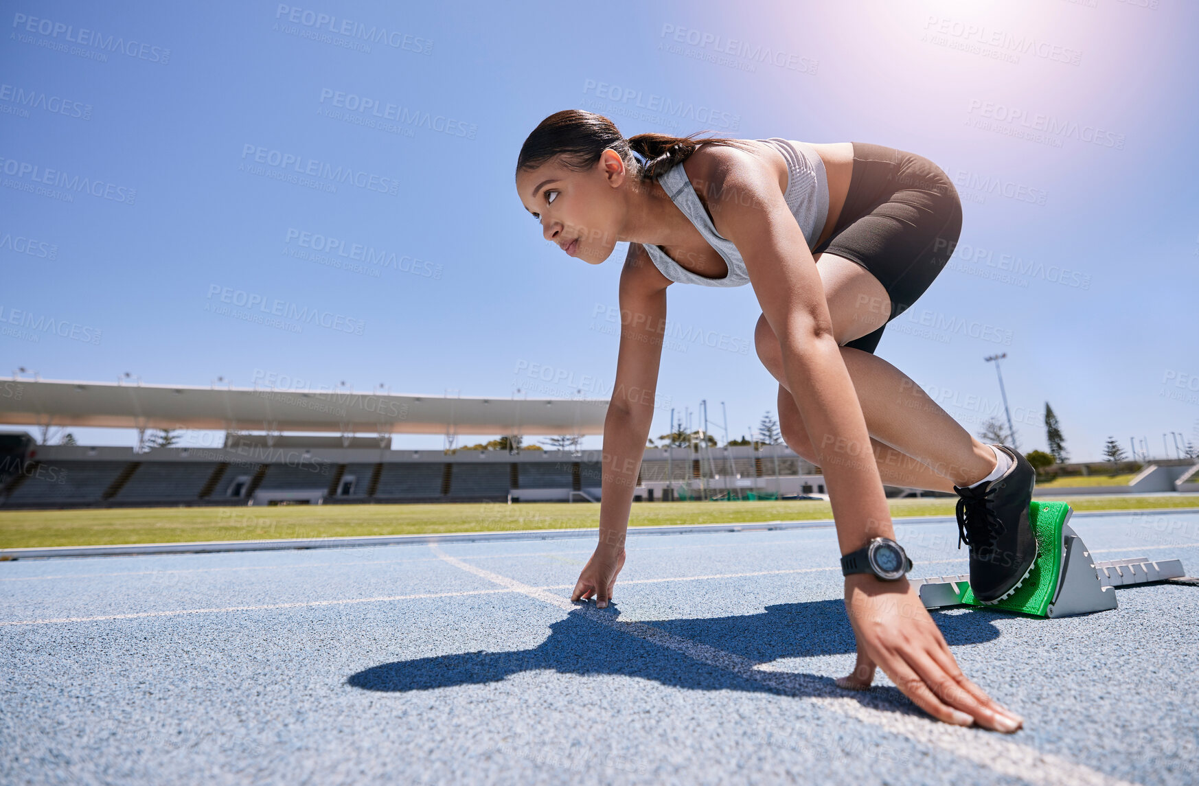 Buy stock photo Athlete, runner and race for a woman running a marathon at a sports track or stadium for exercise, training and sport for health, speed and wellness. Fitness girl in position to start run or workout