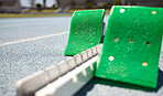 Sports closeup, starting blocks and running track, field or pitch for training, exercise or sprint in arena. Start, ready and race with equipment for sport, fitness or workout on ground at stadium