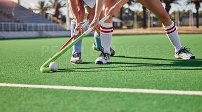 Hockey, field and athletes playing a game at a championship or sports training at an outdoor stadium. Fitness, action and team with sticks and a ball doing a exercise or skill on a sport turf court.