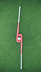 Hockey, sticks and ball on turf grass at a stadium for a sports match, exercise or training. Fitness, workout and sport equipment on outdoor field for championship game, practice or skill development