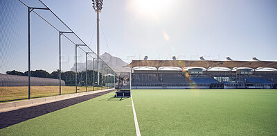 Field, sports and hockey ground at empty stadium for fitness, training or professional game day. Competition, exercise or sport playground for athletic cardio turf with Canada sun flare.