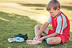 Soccer, injury and pain of child foot on field cry for medical emergency, healthcare insurance and wellness. Football, soccer field and sad kid crying with legs massage for sports training accident