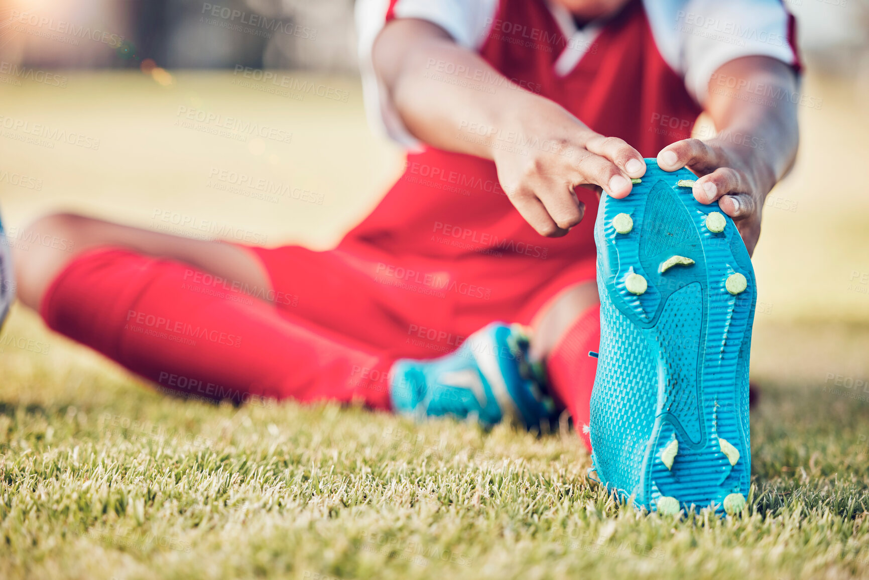 Buy stock photo Stretching, foot and soccer player on field for sports training, exercise and legs muscle wellness health zoom. Football athlete with shoes or sneakers gear for warmup workout or game on grass pitch