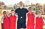 Soccer, football coach and kids team stand in goal post for team photo, before team game and teamwork to play competitive match. Happy sports players, grass soccer field and sport group collaboration