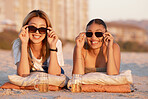 Beach, happy and friends relaxing with sunglasses while on a summer vacation together in Mauritius. Freedom, travel and women on a tropical holiday, adventure or journey in nature by the ocean or sea