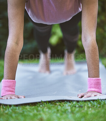 Buy stock photo Yoga, hands and mat with a woman plank closeup outdoor in a grass park for workout or training. Wellness, health and fitness with a female yogi exercising outside on grass in a garden for balance