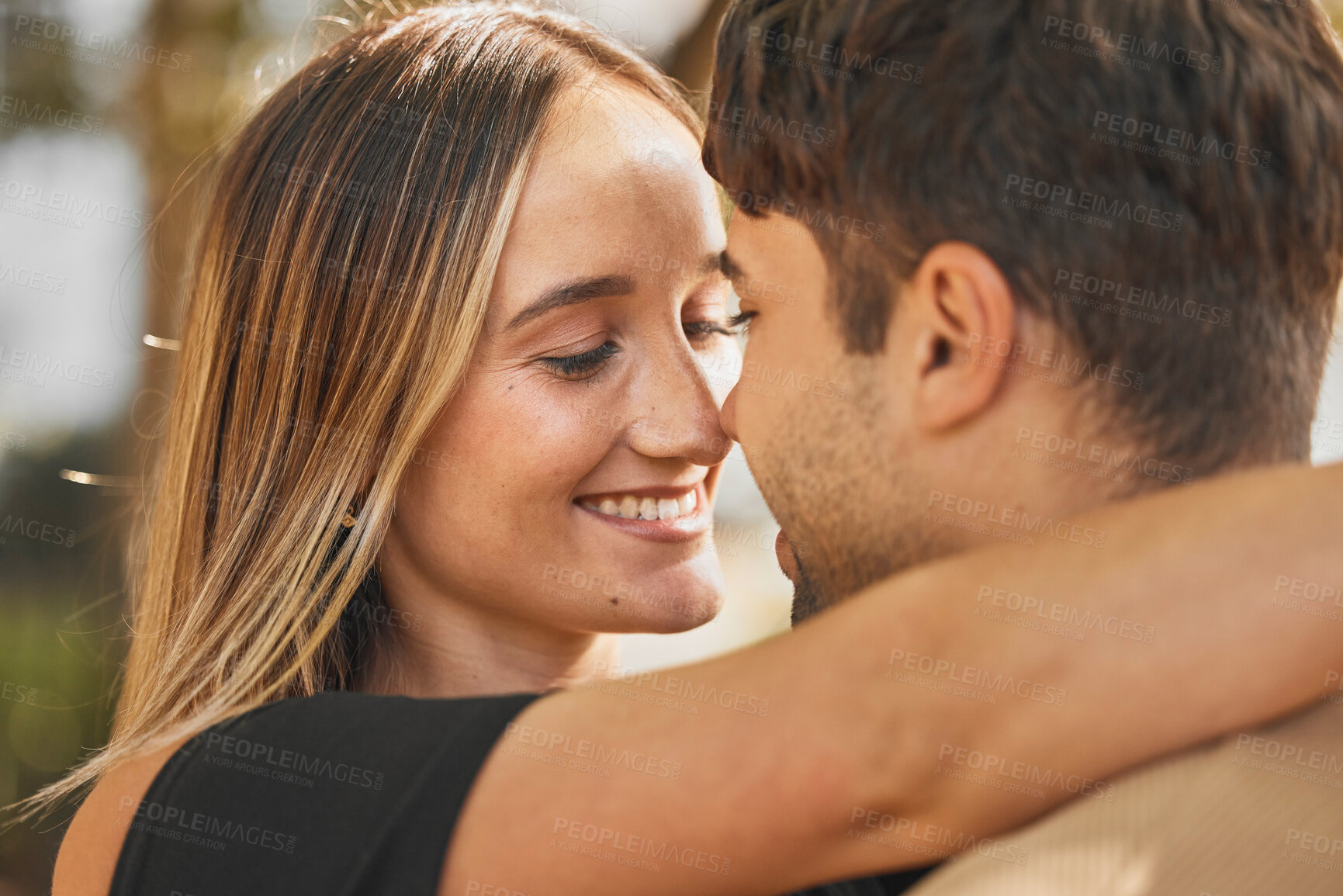 Buy stock photo Couple, hug and love with happiness outdoor, romance and bonding with face together and nose touch. Happy, trust and romantic embrace, man and woman smile in marriage or dating relationship.
