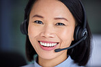 Face, telemarketing and customer support working in a call center with happy smile. Asian customer service operator with headset consulting, help and online advice for contact us, crm and consultant