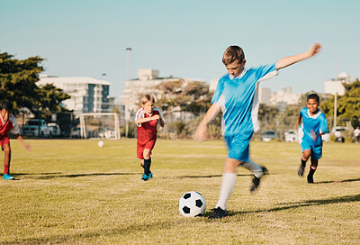 Soccer, boys running and kicking ball on field in summer, motivation and sports workout goals. Football, teamwork and growth, children playing game on grass soccer field in urban park with kids team.