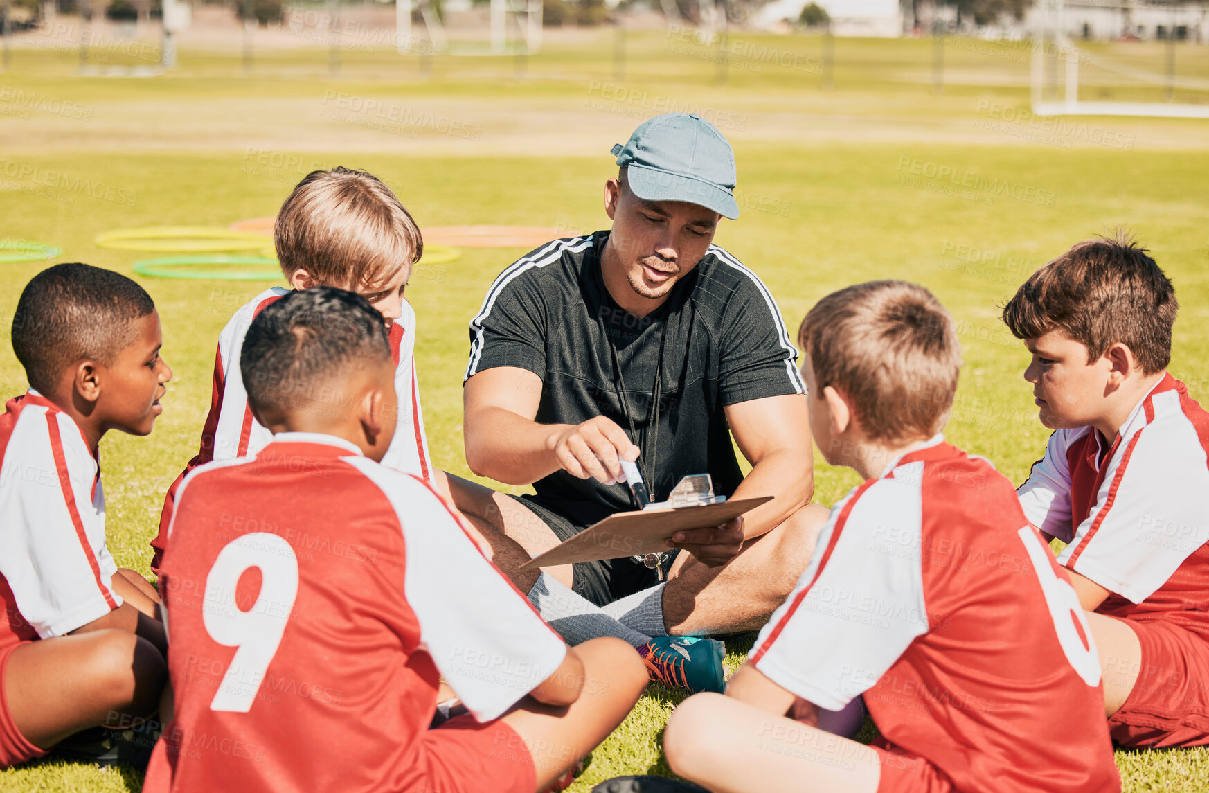 Buy stock photo Teamwork, coaching and football with children on field for training, fitness and sports goals. Planning, pitch and strategy with mentor and soccer player kids learning for exercise, games and manager