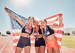 Winner, sports and usa with a woman team holding a flag after winning a race on track for competition. Fitness, teamwork and diversity with an American female group in celebration of victory together