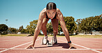 Sports, running and fitness with a woman athlete starting a race on a track for competitive training or exercise. Health, workout and energy with a young female runner at a sport stadium for cardio