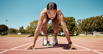 Buy stock photo Sports, running and fitness with a woman athlete starting a race on a track for competitive training or exercise. Health, workout and energy with a young female runner at a sport stadium for cardio