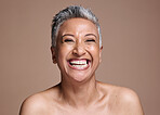 Skincare, beauty and portrait of a senior woman with a smile, happy and relax against a brown mockup studio background. Wellness, luxury and face of an elderly model in retirement and happiness