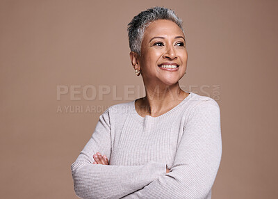 Buy stock photo Happy woman, fashion and beauty in studio while thinking about motivation, dream or idea for cosmetics, makeup and dermatology mockup. Smile, happiness and face of a mature model on brown background 