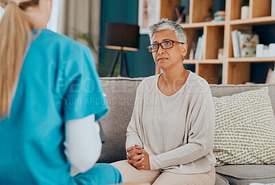 Buy stock photo Nurse, senior woman and consultation on sofa in home for health check up or examination. Healthcare, consulting and female doctor with elderly patient in living room discussing treatment options.