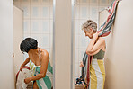 Bathroom, summer and swimwear with a senior woman friends getting ready in a changing room while on holiday. Travel, retirement and locker room with a mature female and friend enjoying a vacation