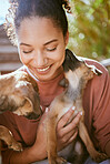 Happy, care and girl playing with dogs at animal adoption center with excited smile holding puppy. Happiness, black woman and loyalty of foster pets with caring lick for bond and trust.

