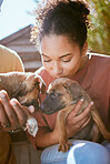 Love, dog and animal shelter with a black woman kissing a puppy at a rescue pound for adoption or care. Pet, homeless and foster with a female volunteer adopting a canine companion to rehome