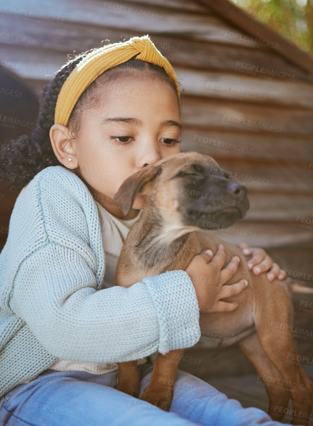 Buy stock photo Child, pet animal and kiss for love, care and happiness for dog, fun friend or partner. Black girl outdoor for adoptoion with healthy rescue puppy for development to learn responsibility and kindness