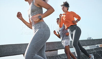 Women, black man and running in city fitness, workout or exercise for cardio health, wellness or marathon training. Sports people, friends or runner athletes on New York street with energy or speed