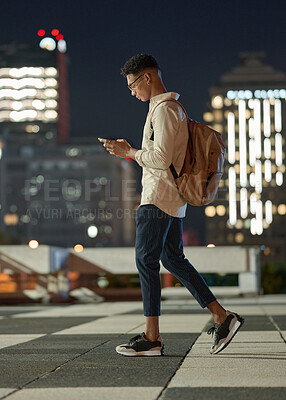 Buy stock photo Night, man and phone while walking in a city with social media, networking and searching the internet. Male text contact, online and networking with internet contact on app with mobile smartphone