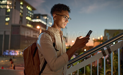 Buy stock photo Man, city night and phone text of a student on social media app, internet or web search. Black man with mobile technology in the dark online reading and texting with a 5g connection outdoor