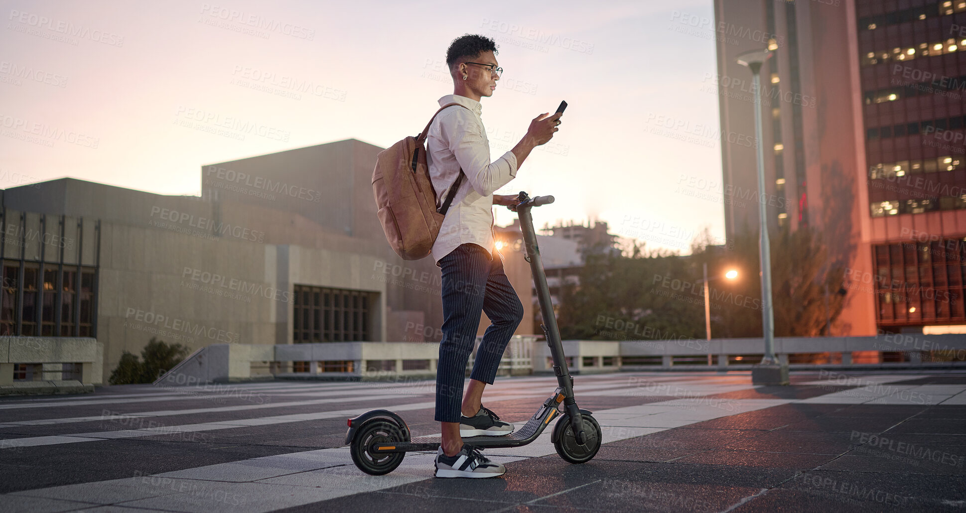 Buy stock photo Creative student, electric scooter or man with phone is city, street or building at night networking, 5g network or social media. Travel, designer or male with smartphone for contact us or media app