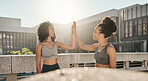 Fitness, friends and high five in the city for exercise, training or workout together in the outdoors. Happy women in partnership touching hands for sports support, success or healthy cardio wellness