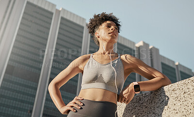 Buy stock photo Black woman, city fitness and music earphones for sports motivation, exercise and workout in urban town from below. Focus, strong and healthy athlete listening to audio outdoors for wellness training